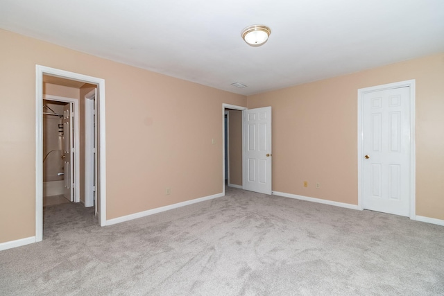 unfurnished bedroom featuring light carpet