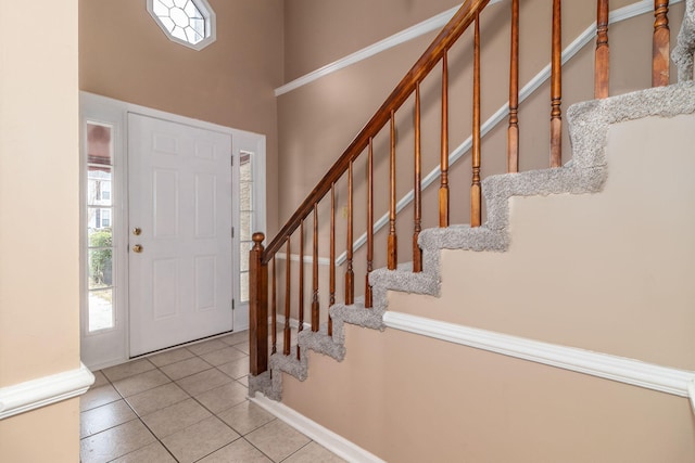 entrance foyer with light tile patterned floors and a wealth of natural light