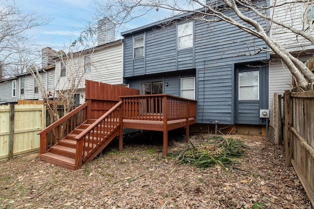 back of house featuring a wooden deck