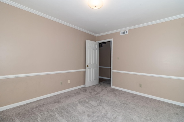 spare room with ornamental molding and light carpet