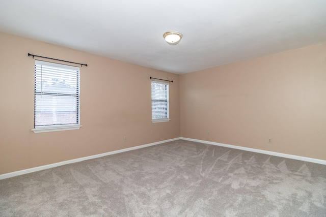 unfurnished room featuring light carpet