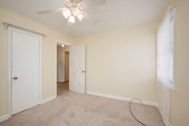 2011 Denmark Dr, Augusta, GA 30906 - unfurnished bedroom featuring a ceiling fan, baseboards, light colored carpet, and multiple windows