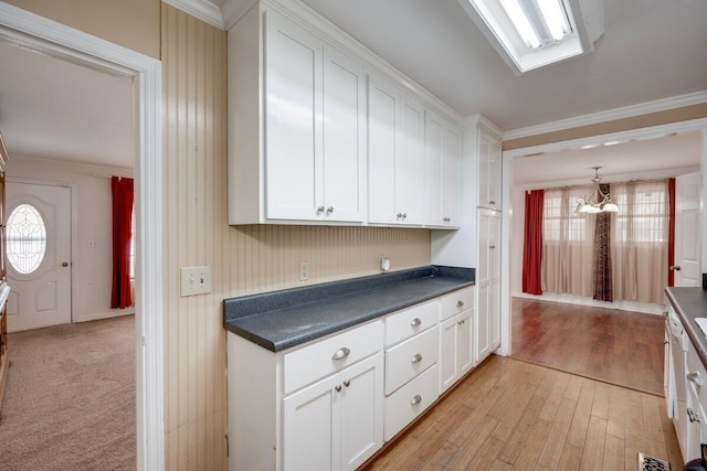 2011 Denmark Dr, Augusta, GA 30906 - kitchen featuring ornamental molding, white cabinets, dark countertops, and a healthy amount of sunlight