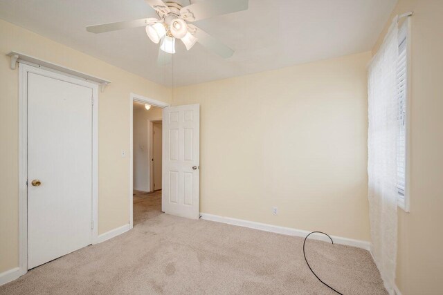 2011 Denmark Dr, Augusta, GA 30906 - unfurnished bedroom with a ceiling fan, baseboards, light carpet, and multiple windows