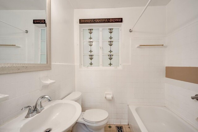 2011 Denmark Dr, Augusta, GA 30906 - bathroom featuring tile patterned flooring, toilet, tile walls, a wainscoted wall, and a sink