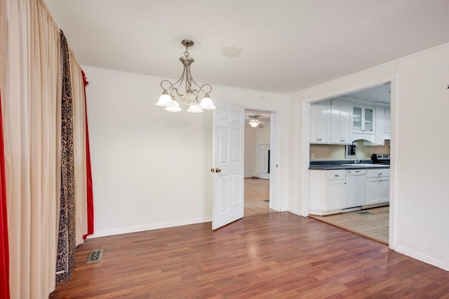 2011 Denmark Dr, Augusta, GA 30906 - unfurnished dining area with visible vents, light wood-type flooring, a sink, baseboards, and ceiling fan with notable chandelier