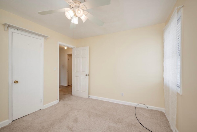 2011 Denmark Dr, Augusta, GA 30906 - unfurnished bedroom with baseboards, multiple windows, light carpet, and ceiling fan