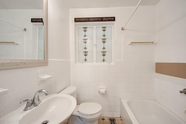 2011 Denmark Dr, Augusta, GA 30906 - bathroom featuring tile patterned flooring, toilet, tile walls, a wainscoted wall, and a sink