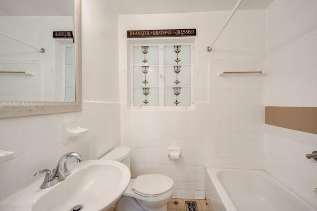 2011 Denmark Dr, Augusta, GA 30906 - bathroom featuring toilet, tile walls, a wainscoted wall, tile patterned floors, and a sink