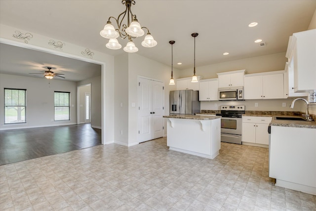 863 Westlawn Dr, Grovetown, GA 30813 - kitchen featuring stainless steel appliances, a sink, open floor plan, a center island, and white cabinetry