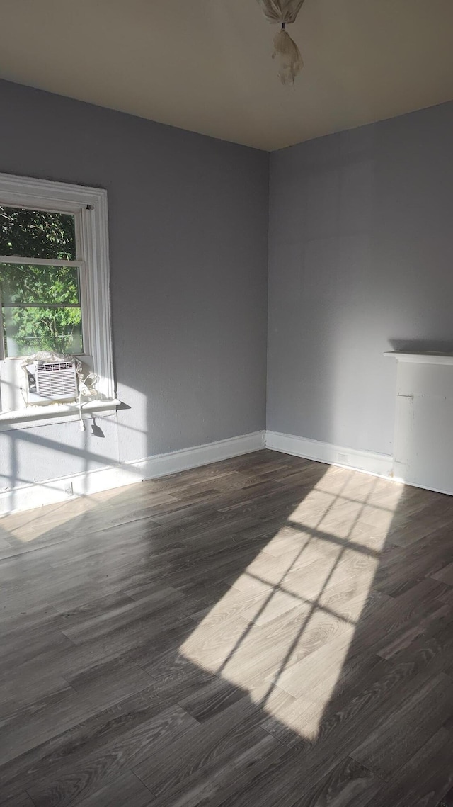 spare room with hardwood / wood-style flooring and cooling unit