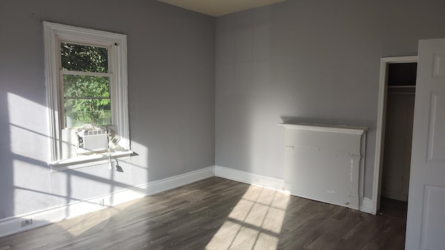 empty room with cooling unit and dark hardwood / wood-style floors