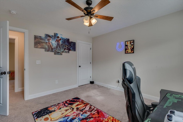 office featuring ceiling fan and light carpet