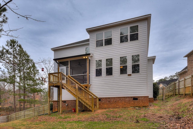 rear view of property with ceiling fan and a sunroom