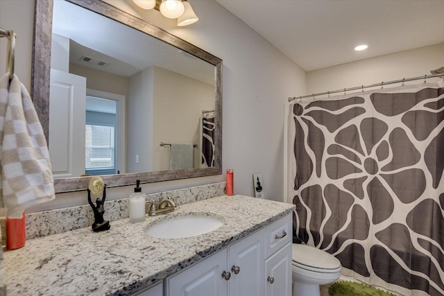 bathroom featuring toilet and vanity