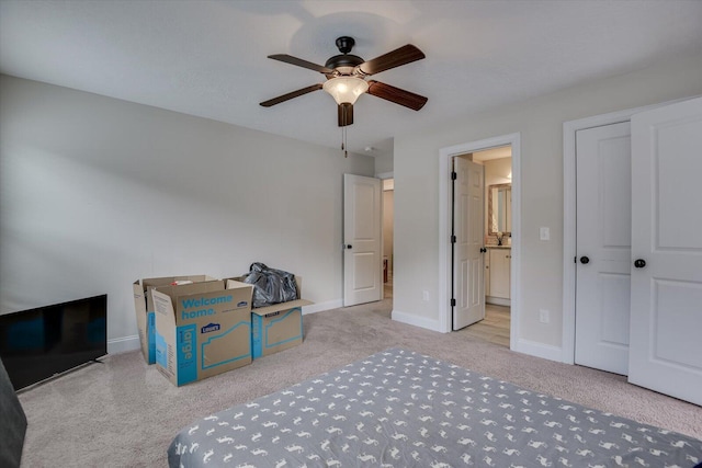 carpeted bedroom with connected bathroom and ceiling fan