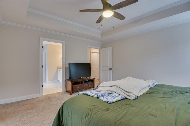 bedroom featuring ceiling fan, ornamental molding, and a tray ceiling