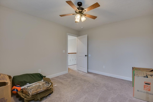 interior space featuring light colored carpet and ceiling fan