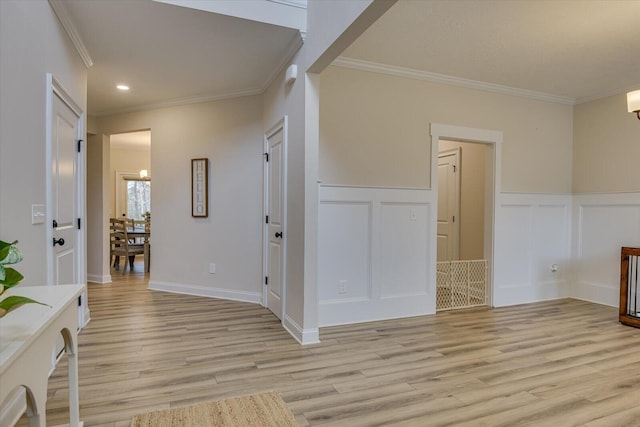 interior space featuring light hardwood / wood-style floors, crown molding, and a chandelier