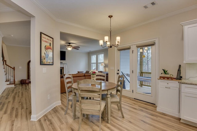 dining space with ceiling fan with notable chandelier, light hardwood / wood-style floors, and crown molding