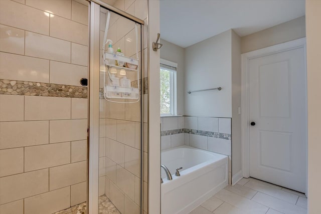 bathroom featuring shower with separate bathtub and tile patterned floors