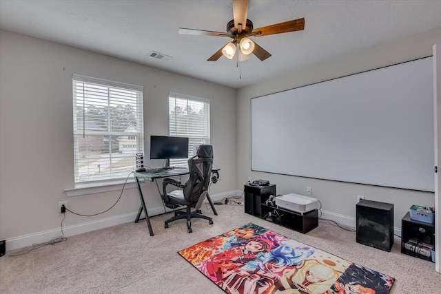 carpeted office space featuring ceiling fan