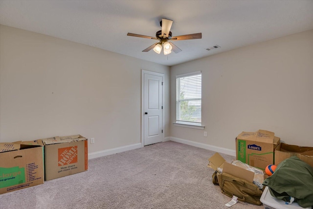 miscellaneous room with ceiling fan and light carpet