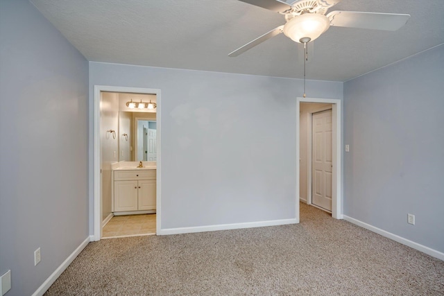 2288 William Few Pkwy, Evans, GA 30809 - unfurnished bedroom featuring light carpet, baseboards, ensuite bath, and ceiling fan