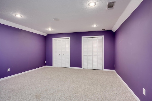 2288 William Few Pkwy, Evans, GA 30809 - unfurnished bedroom with multiple closets, carpet flooring, baseboards, recessed lighting, and a textured ceiling
