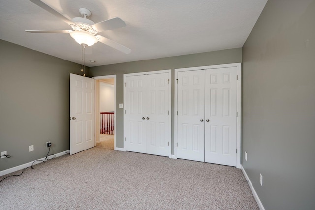 2288 William Few Pkwy, Evans, GA 30809 - unfurnished bedroom with multiple closets, carpet, baseboards, and a ceiling fan