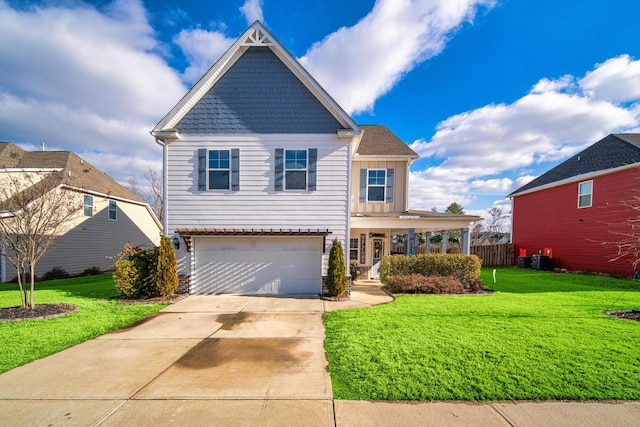 view of front of property featuring covered porch, a front yard, and a garage