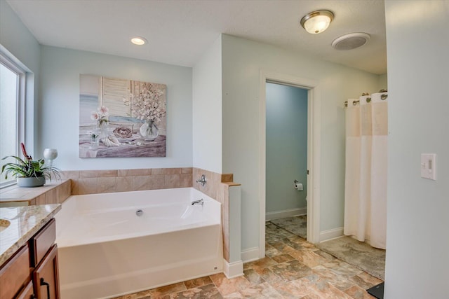 bathroom featuring a bath and vanity