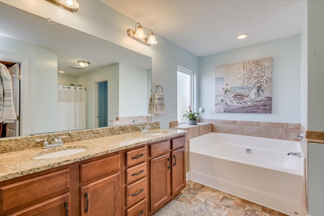 bathroom featuring a washtub and vanity