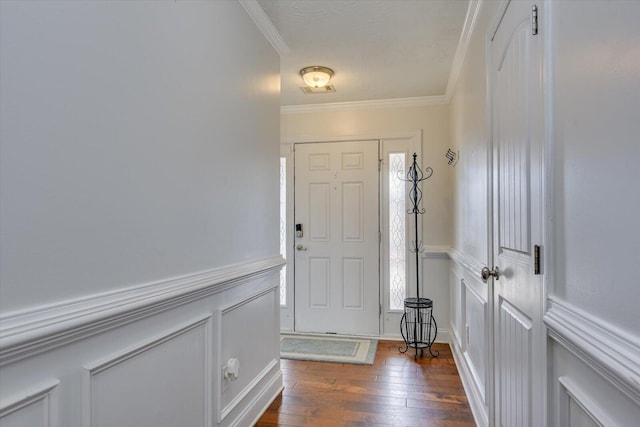 foyer entrance with dark wood-type flooring and ornamental molding