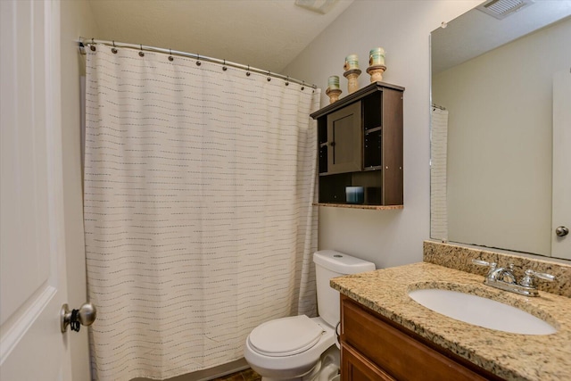 bathroom with toilet and vanity