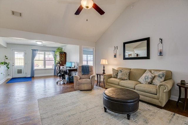 living room with ceiling fan, dark hardwood / wood-style floors, and vaulted ceiling