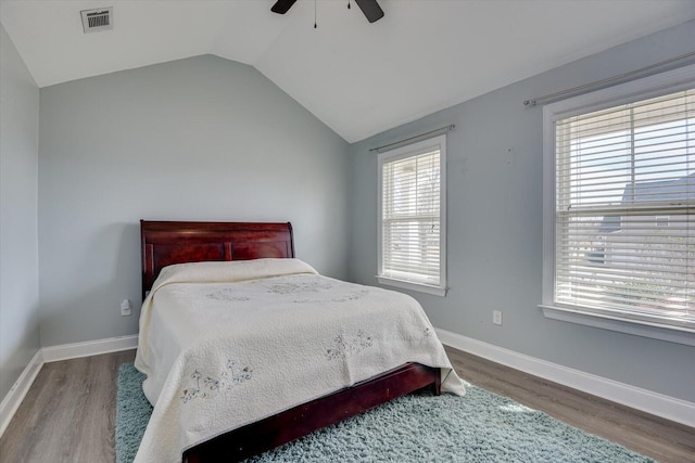 bedroom with ceiling fan, lofted ceiling, and hardwood / wood-style floors