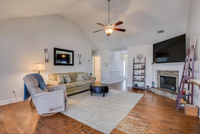 living room featuring ceiling fan, lofted ceiling, a fireplace, and hardwood / wood-style floors