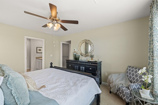 bedroom featuring carpet flooring, ensuite bathroom, and ceiling fan