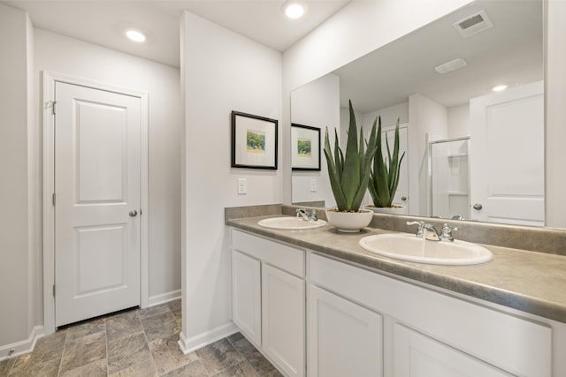 bathroom featuring vanity and a shower with shower door