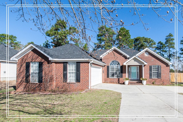 view of front of house with a front yard and a garage