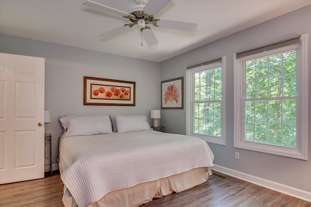 bedroom with hardwood / wood-style floors and ceiling fan