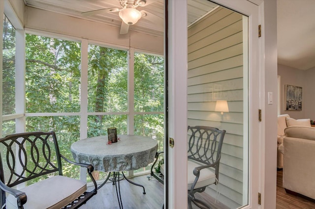 sunroom / solarium featuring ceiling fan