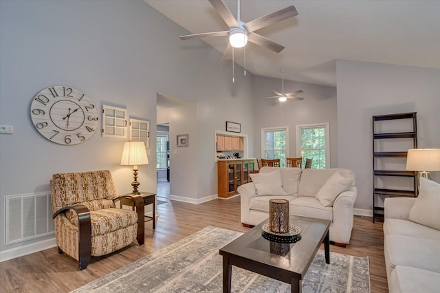 living room featuring high vaulted ceiling and hardwood / wood-style floors