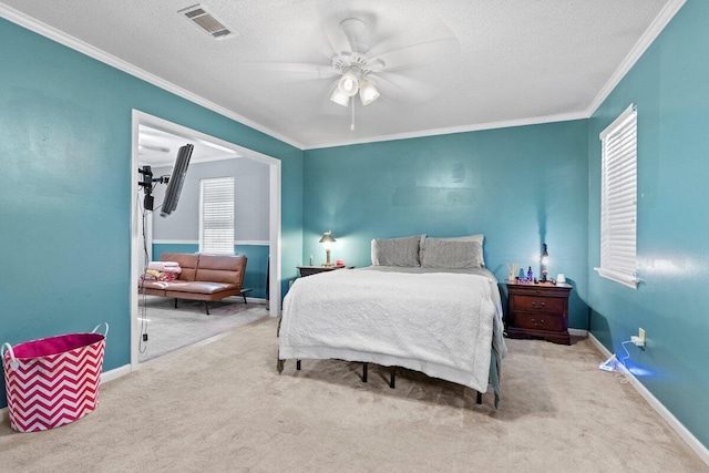 bedroom with ceiling fan, light colored carpet, ornamental molding, and multiple windows