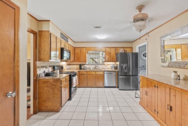 kitchen featuring black appliances, sink, ceiling fan, light tile patterned floors, and tasteful backsplash