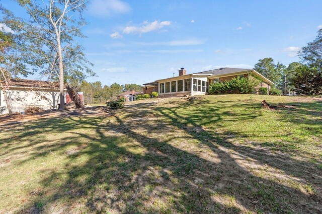 view of yard featuring a sunroom