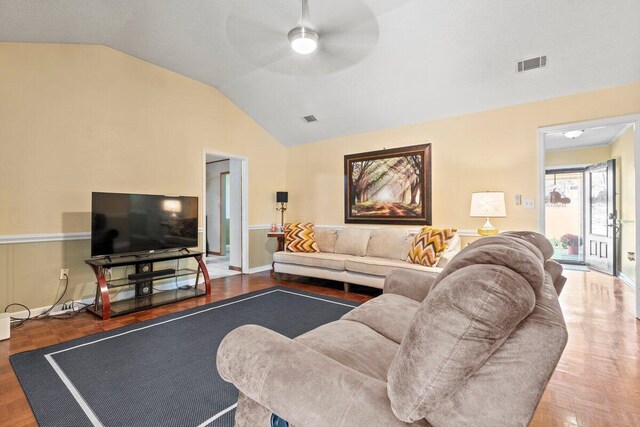 living room featuring ceiling fan, parquet floors, and vaulted ceiling