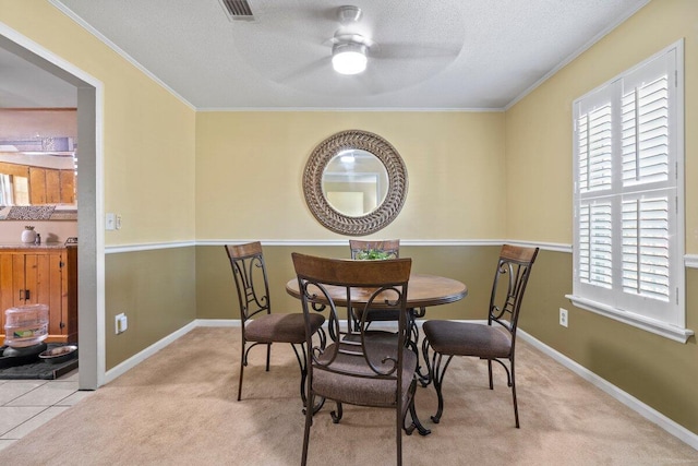 carpeted dining area featuring ceiling fan and ornamental molding