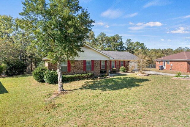 single story home with a garage and a front yard